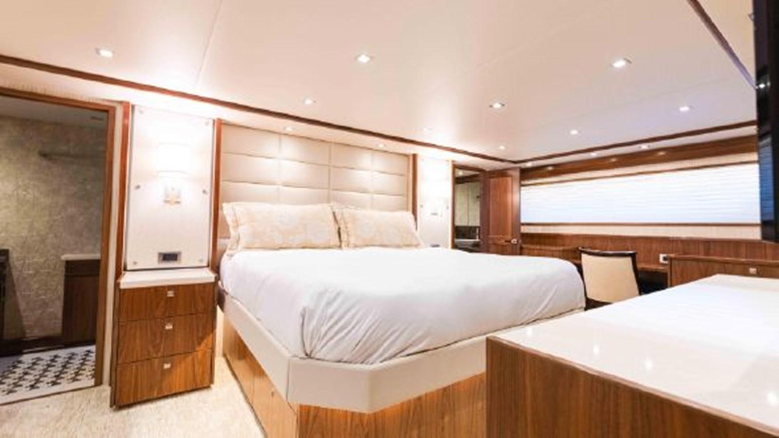 a room with a bed and a desk aboard MAKARA Yacht for Sale