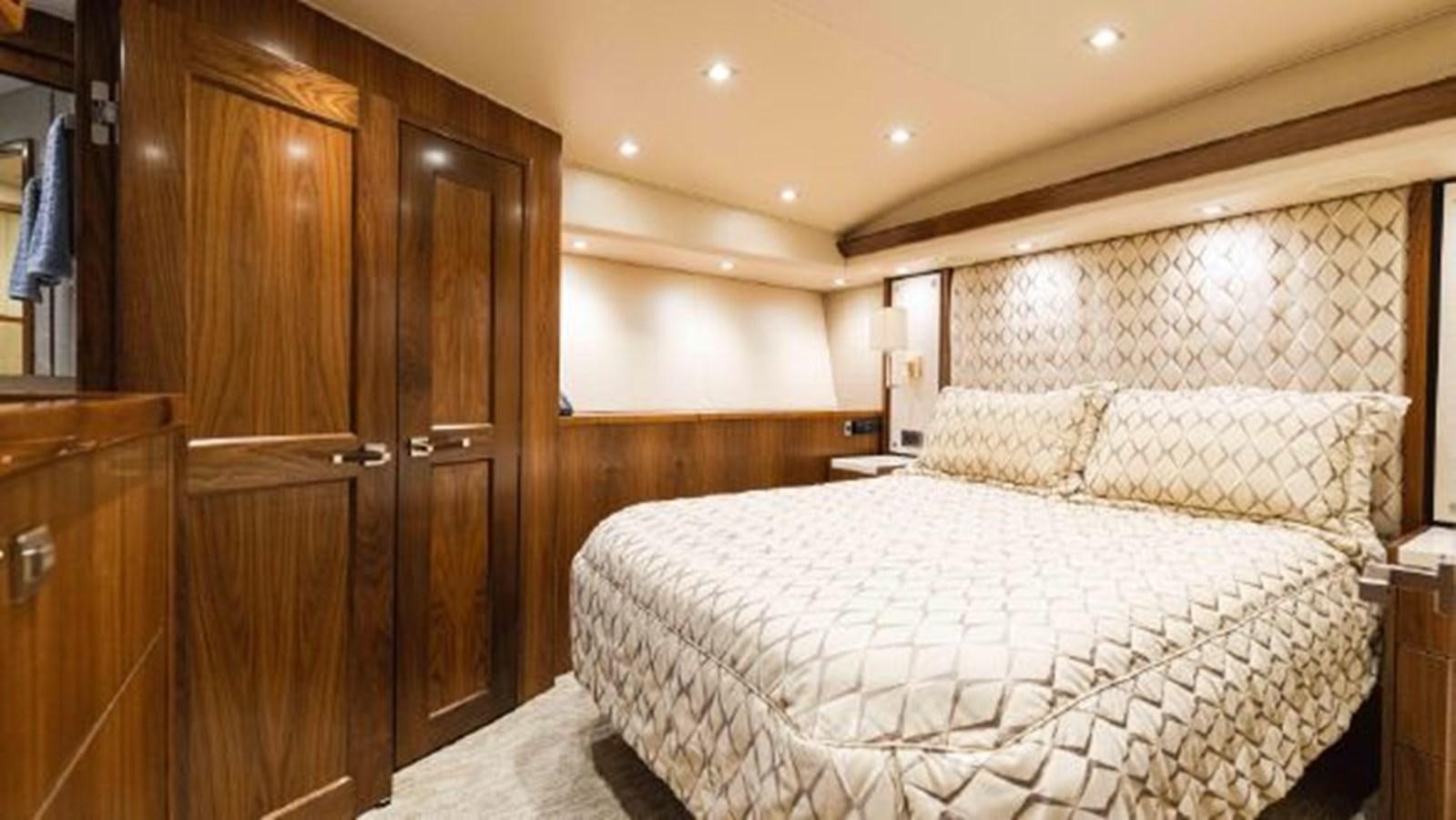 a bedroom with a bed and a closet aboard MAKARA Yacht for Sale