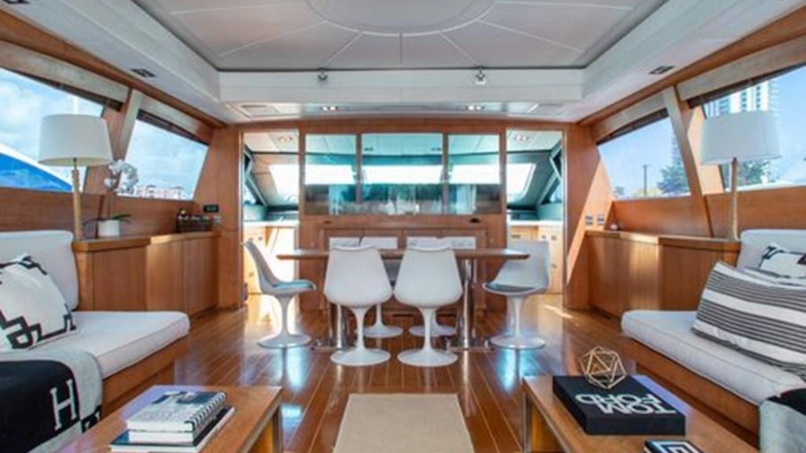 a room with a table chairs and a window aboard SMILE Yacht for Sale