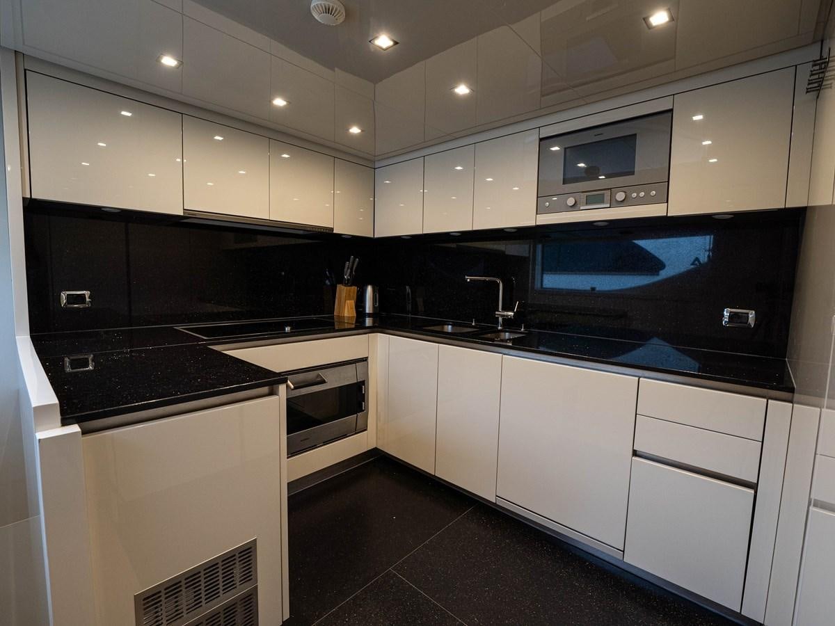 a kitchen with white cabinets aboard BONITA II Yacht for Sale