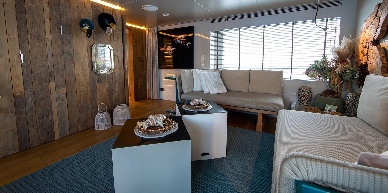 a living room with a couch and a coffee table aboard CALADAN Yacht for Sale