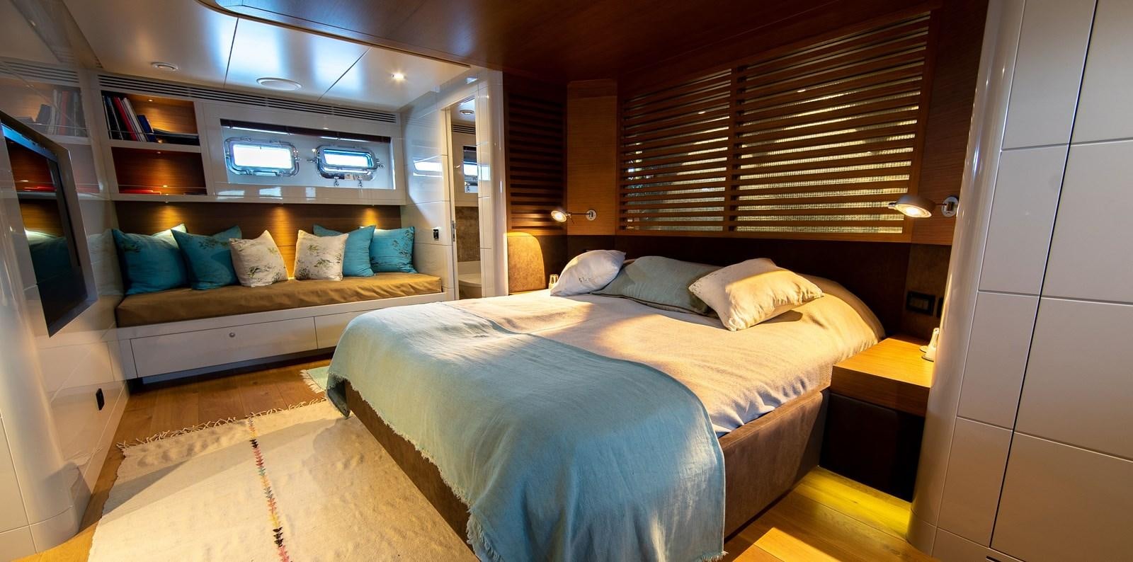 a room with a bed and a couch aboard CALADAN Yacht for Sale