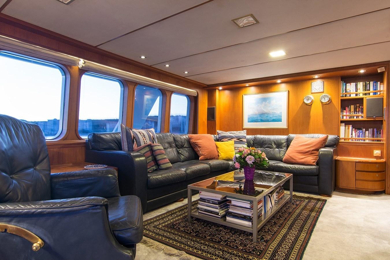 a living room with a couch and a coffee table aboard MOONSHADOW NOA Yacht for Sale