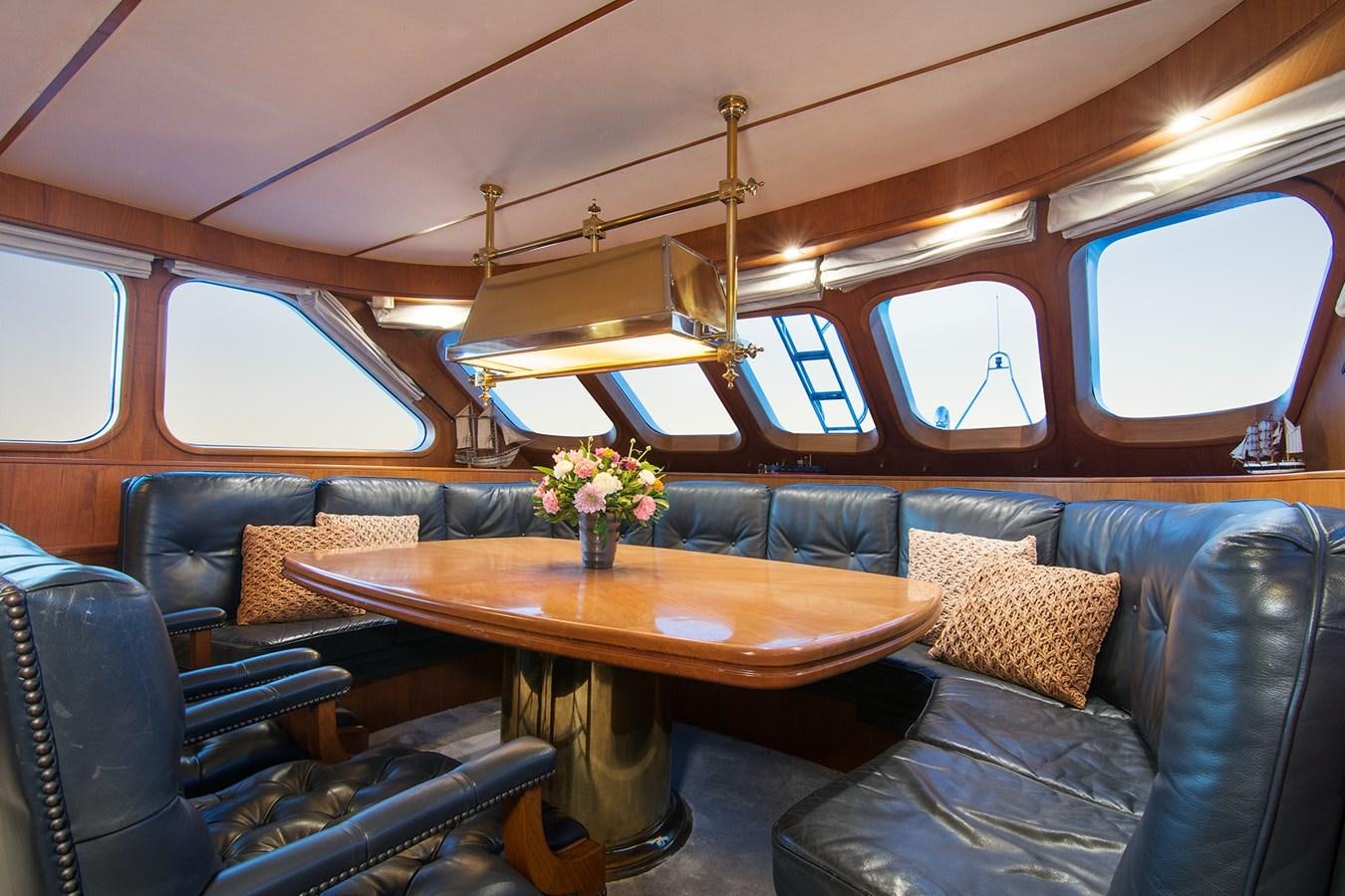 a room with a table and chairs aboard MOONSHADOW NOA Yacht for Sale