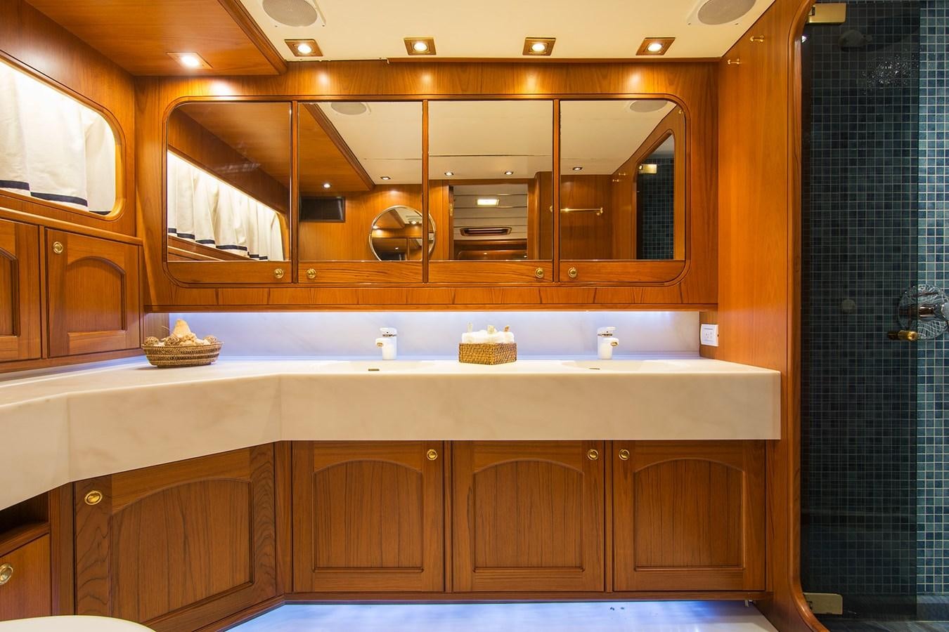 a bathroom with a large mirror aboard MOONSHADOW NOA Yacht for Sale