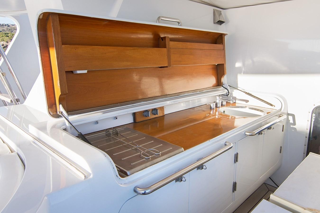 a wooden cabinet above a sink aboard MOONSHADOW NOA Yacht for Sale