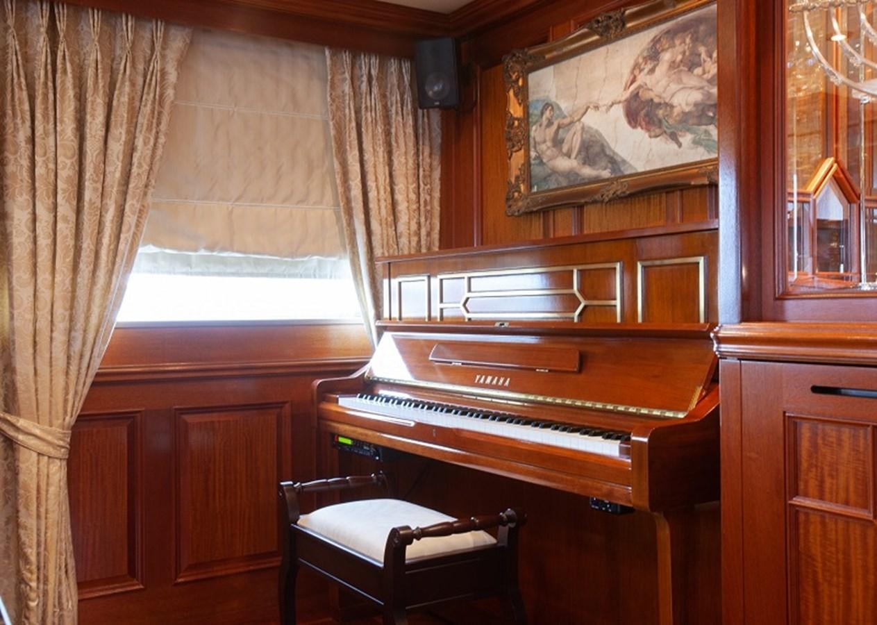 a piano in a room aboard BLUE STAR Yacht for Sale