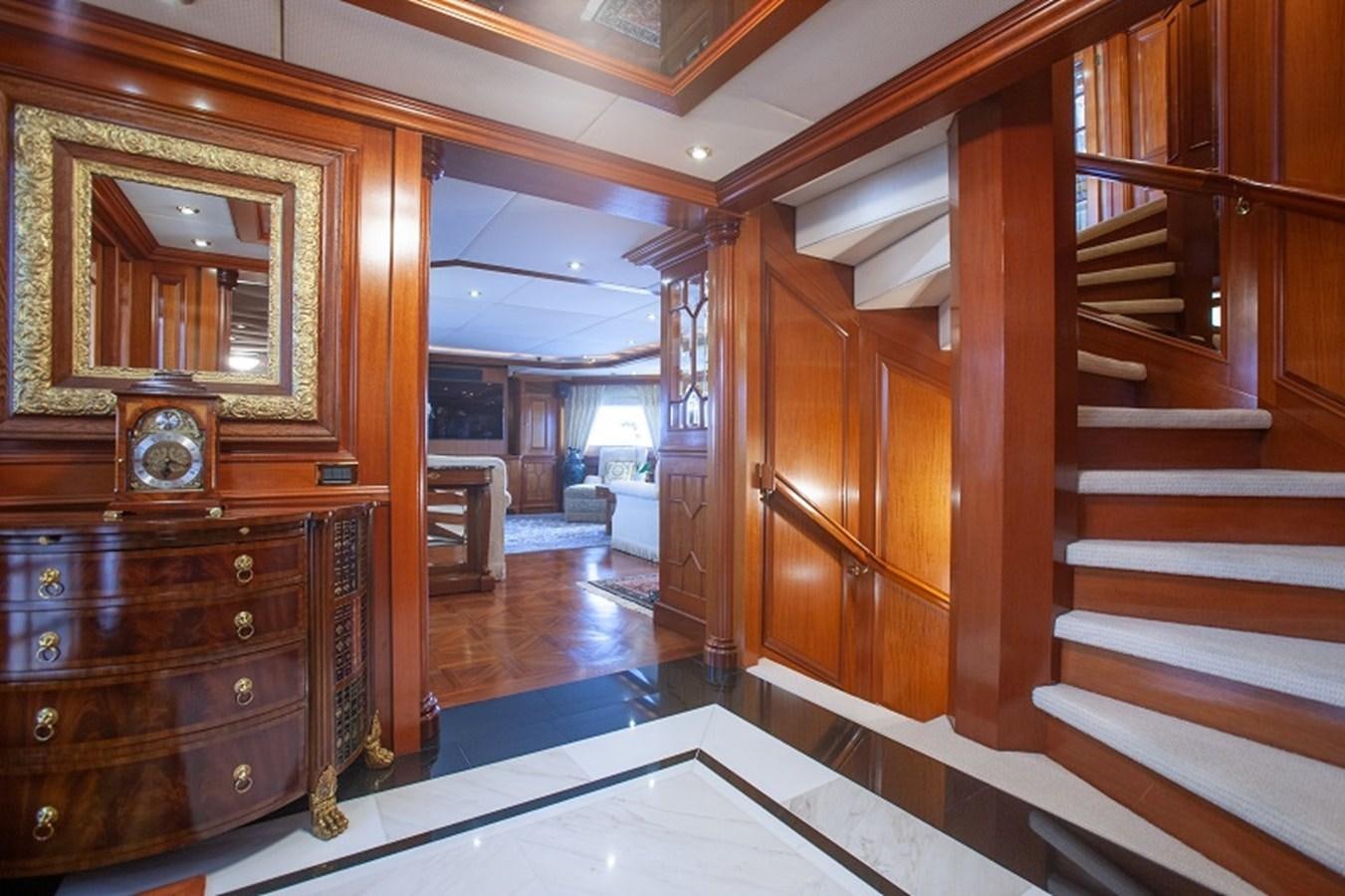 a large wooden room with a large mirror and a clock aboard BLUE STAR Yacht for Sale