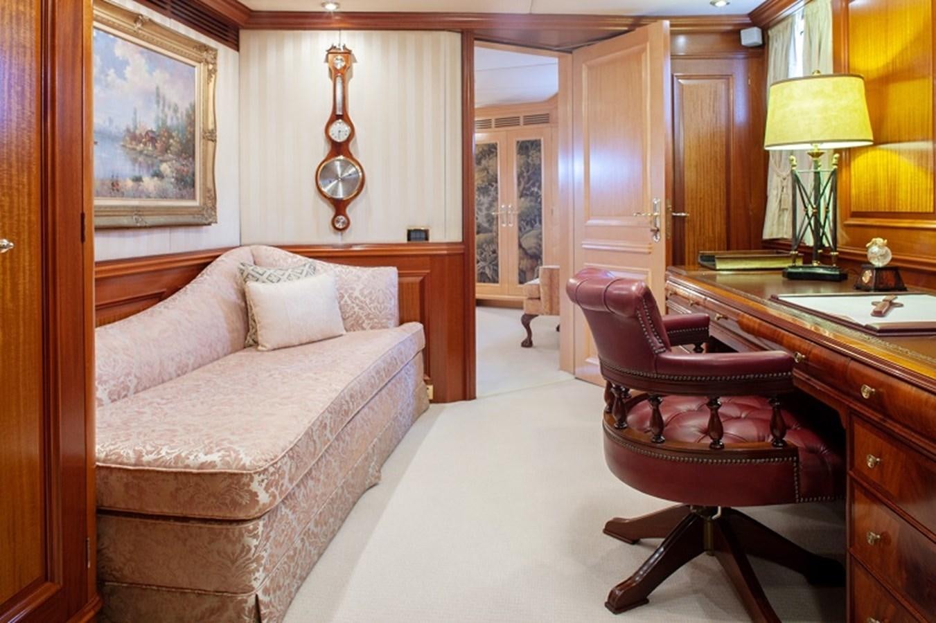 a living room with a couch and a desk aboard BLUE STAR Yacht for Sale