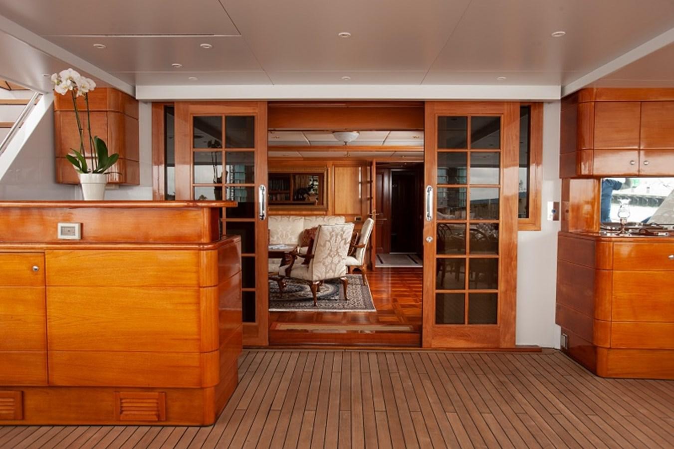 a room with wooden cabinets and a chair and a wood floor aboard BLUE STAR Yacht for Sale