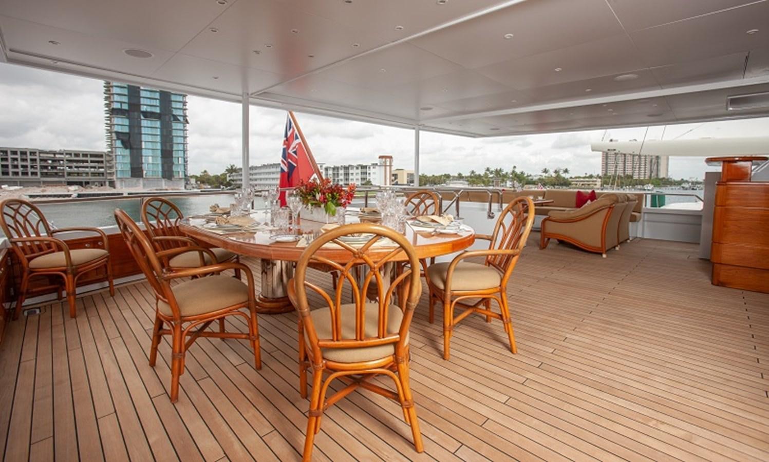 a large room with a table and chairs aboard BLUE STAR Yacht for Sale
