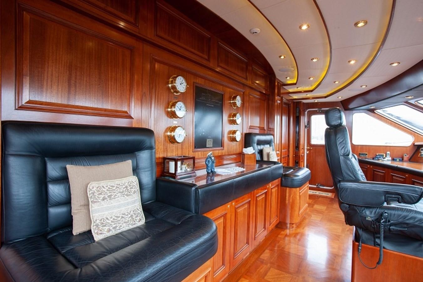 a room with a leather couch and a television set aboard BLUE STAR Yacht for Sale