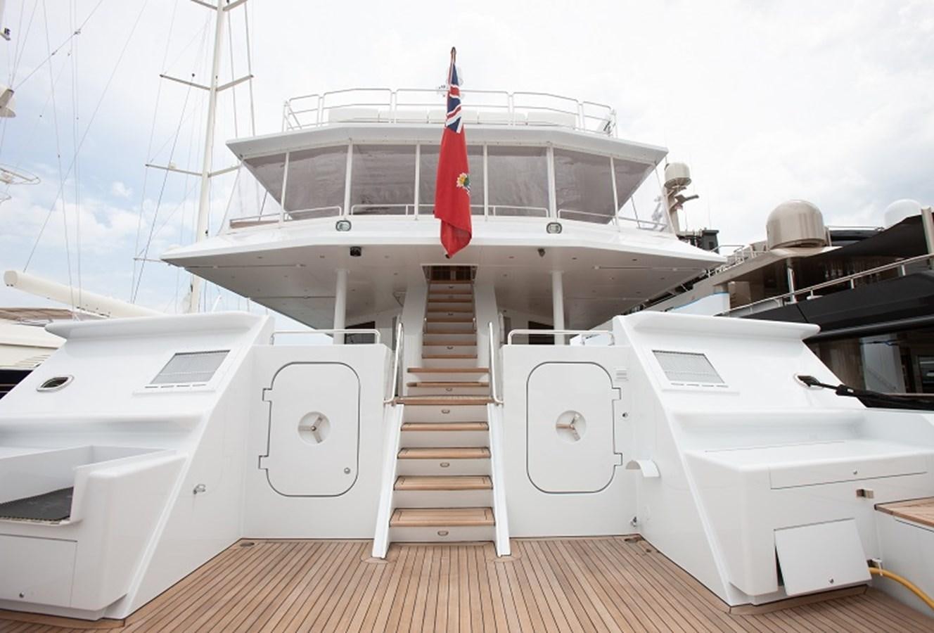 a boat with a red flag on the deck aboard BLUE STAR Yacht for Sale