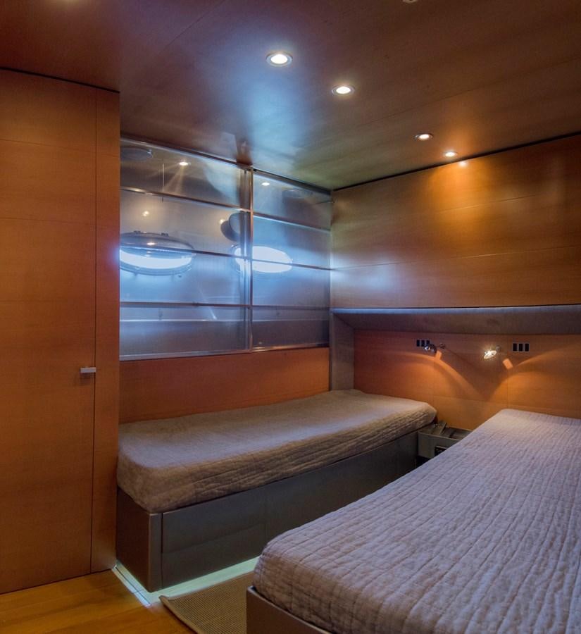 a room with a bed and a mirror aboard NOT GUILTY III Yacht for Sale