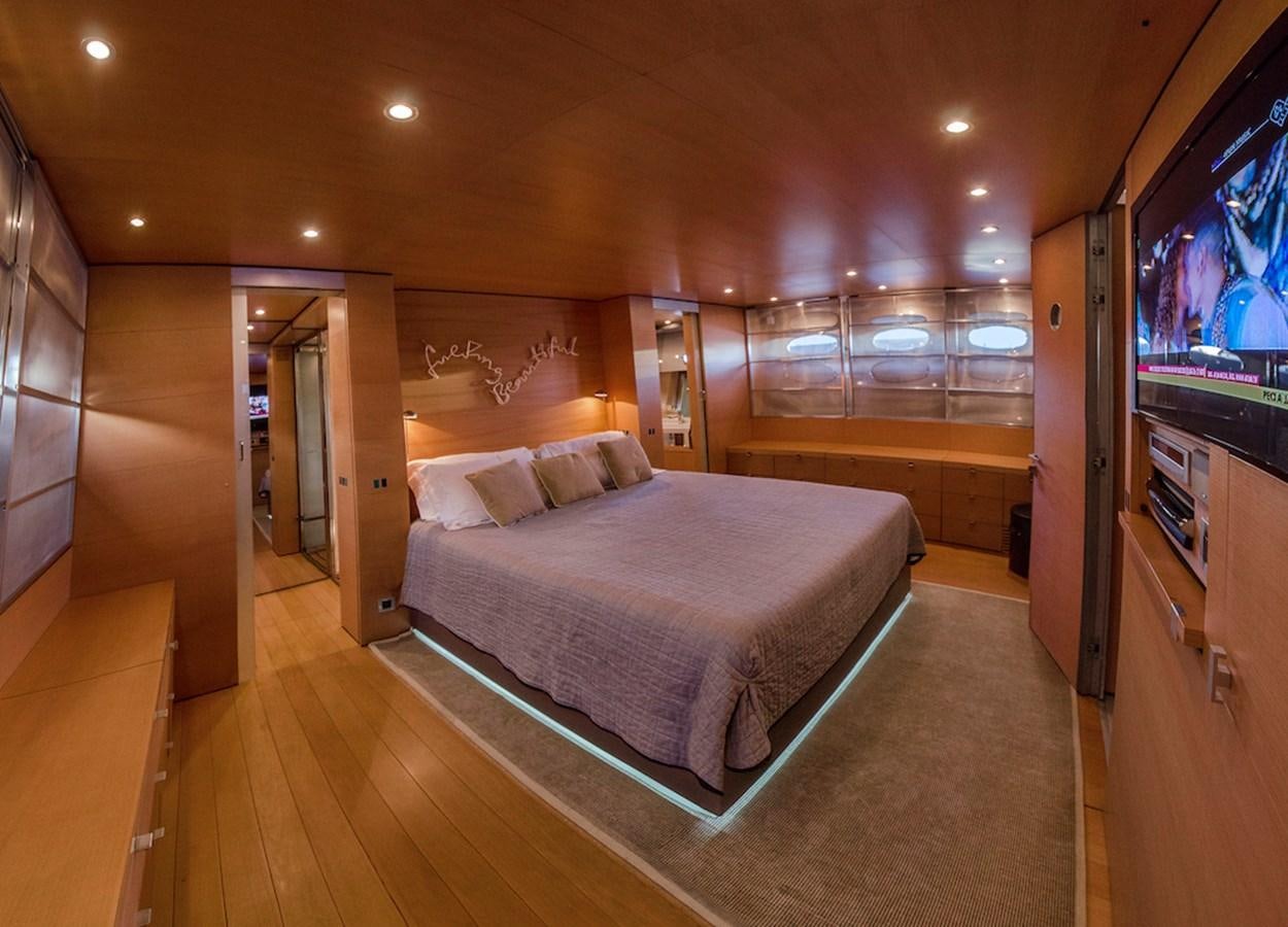 a bedroom with a bed and a tv aboard NOT GUILTY III Yacht for Sale