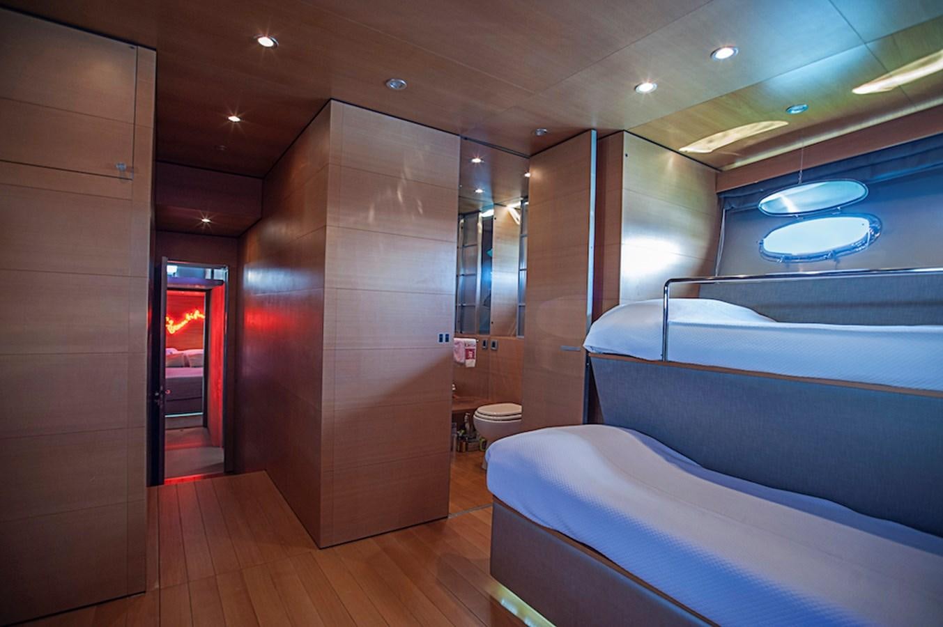 a room with a bed and a wall of glass aboard NOT GUILTY III Yacht for Sale