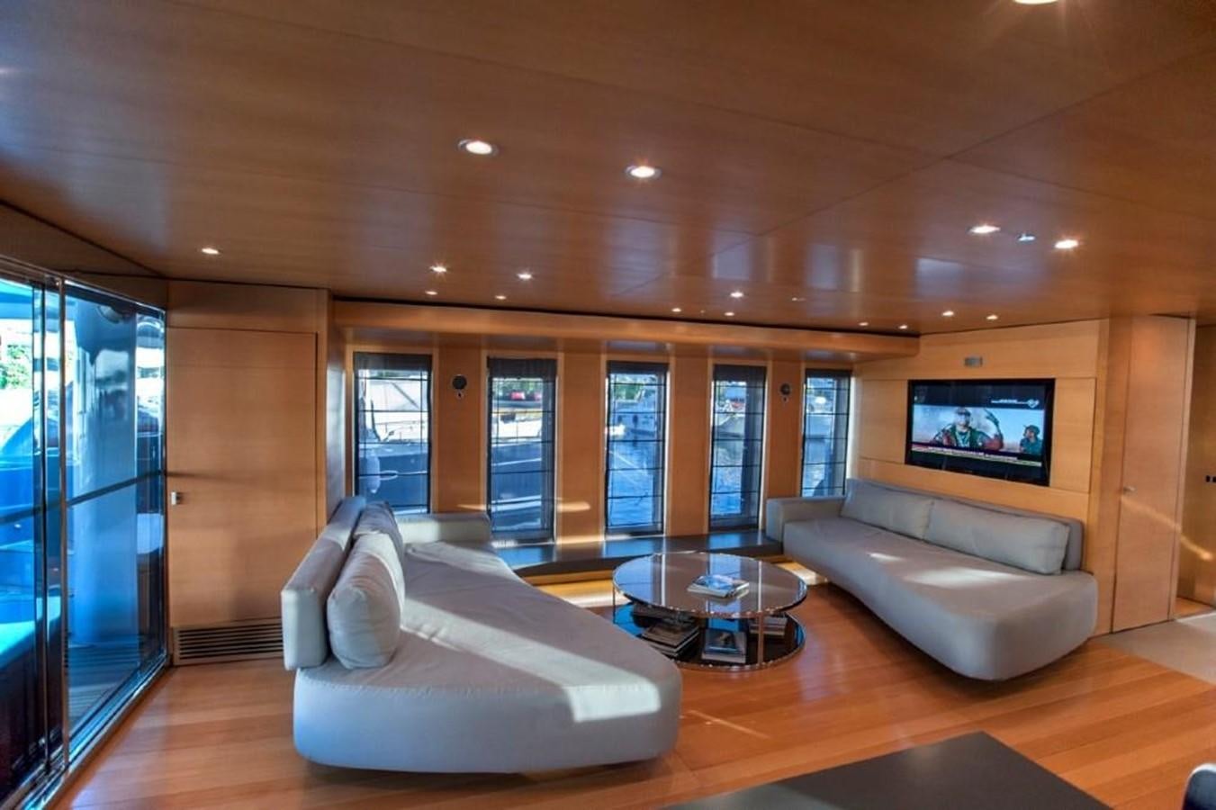 a living room with a large screen aboard NOT GUILTY III Yacht for Sale