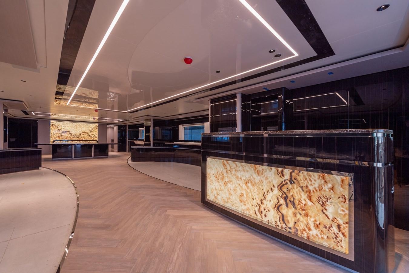 a large room with a large glass wall and a large fireplace aboard BARON TRENCK Yacht for Sale