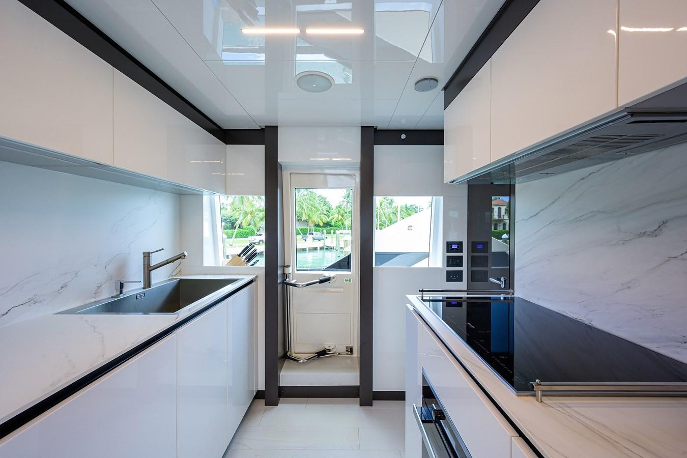 a kitchen with white cabinets aboard DATE NIGHT Yacht for Sale