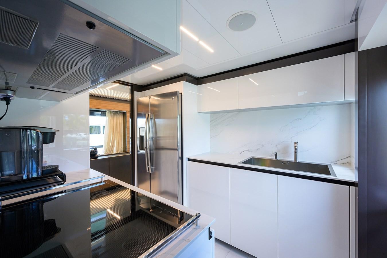 a kitchen with white cabinets aboard DATE NIGHT Yacht for Sale