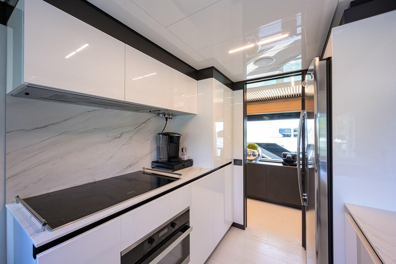 a kitchen with white cabinets aboard DATE NIGHT Yacht for Sale