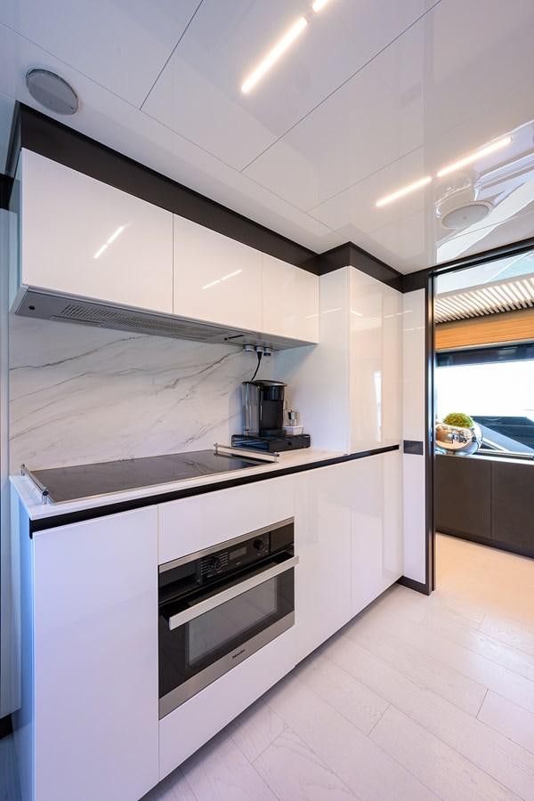 a kitchen with white cabinets aboard DATE NIGHT Yacht for Sale