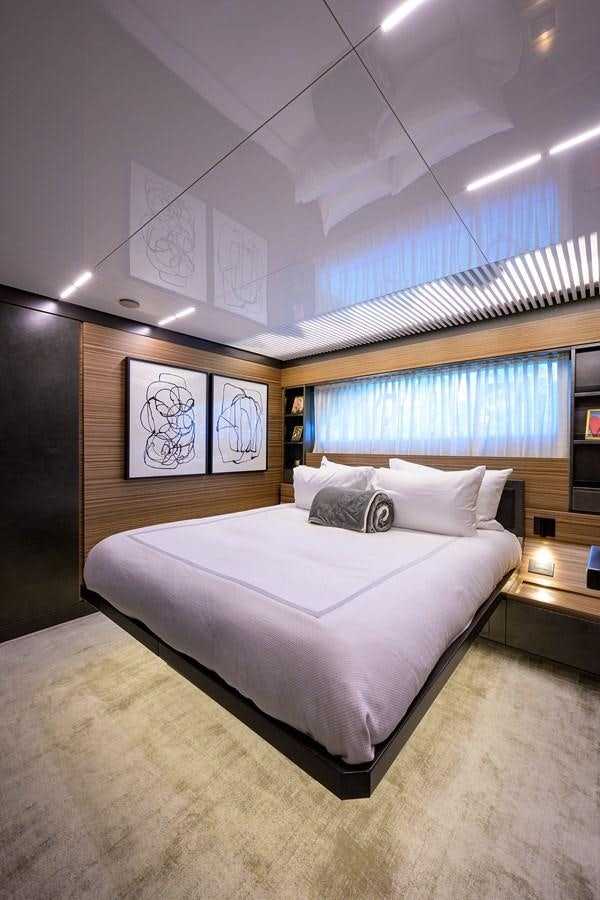 a bedroom with a large bed aboard DATE NIGHT Yacht for Sale