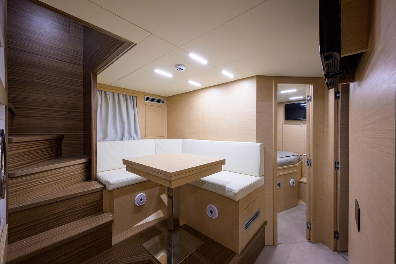 a room with a bed and desk aboard DATE NIGHT Yacht for Sale