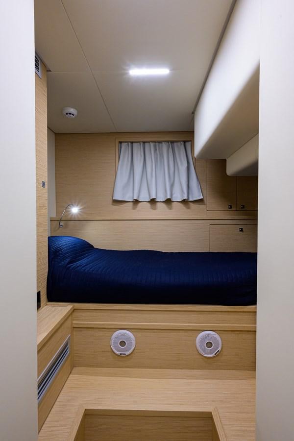 a room with a bed and a window aboard DATE NIGHT Yacht for Sale