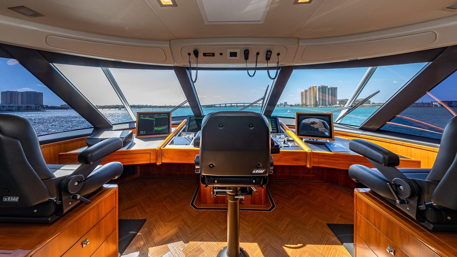 inside of a vehicle with a desk and chairs and a window aboard AUSSIE RULES Yacht for Sale
