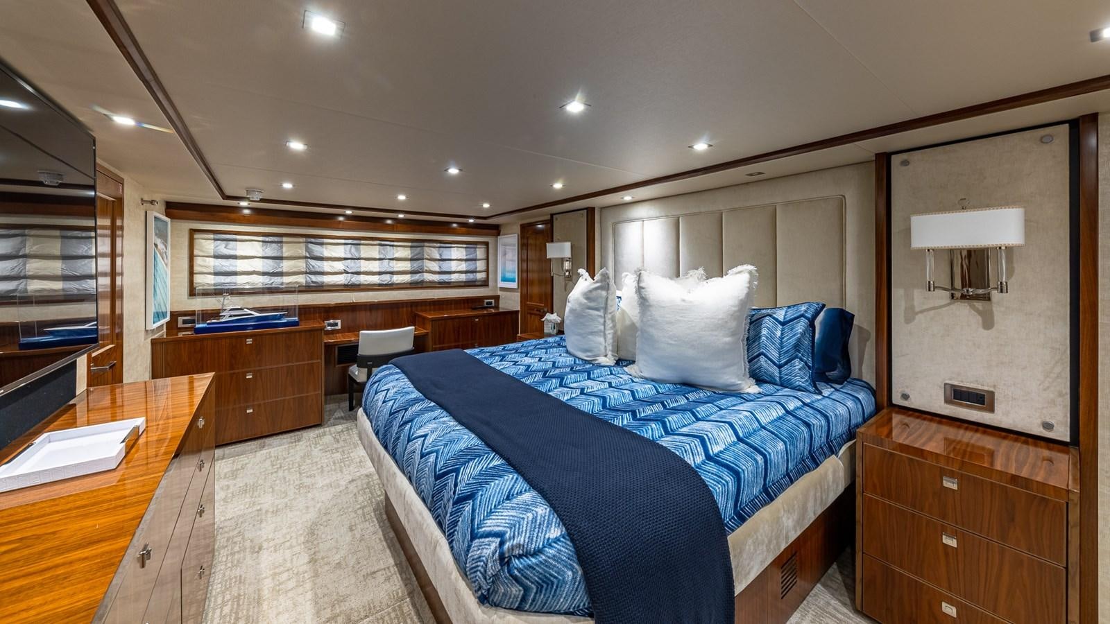a bedroom with a bed and desk aboard AUSSIE RULES Yacht for Sale