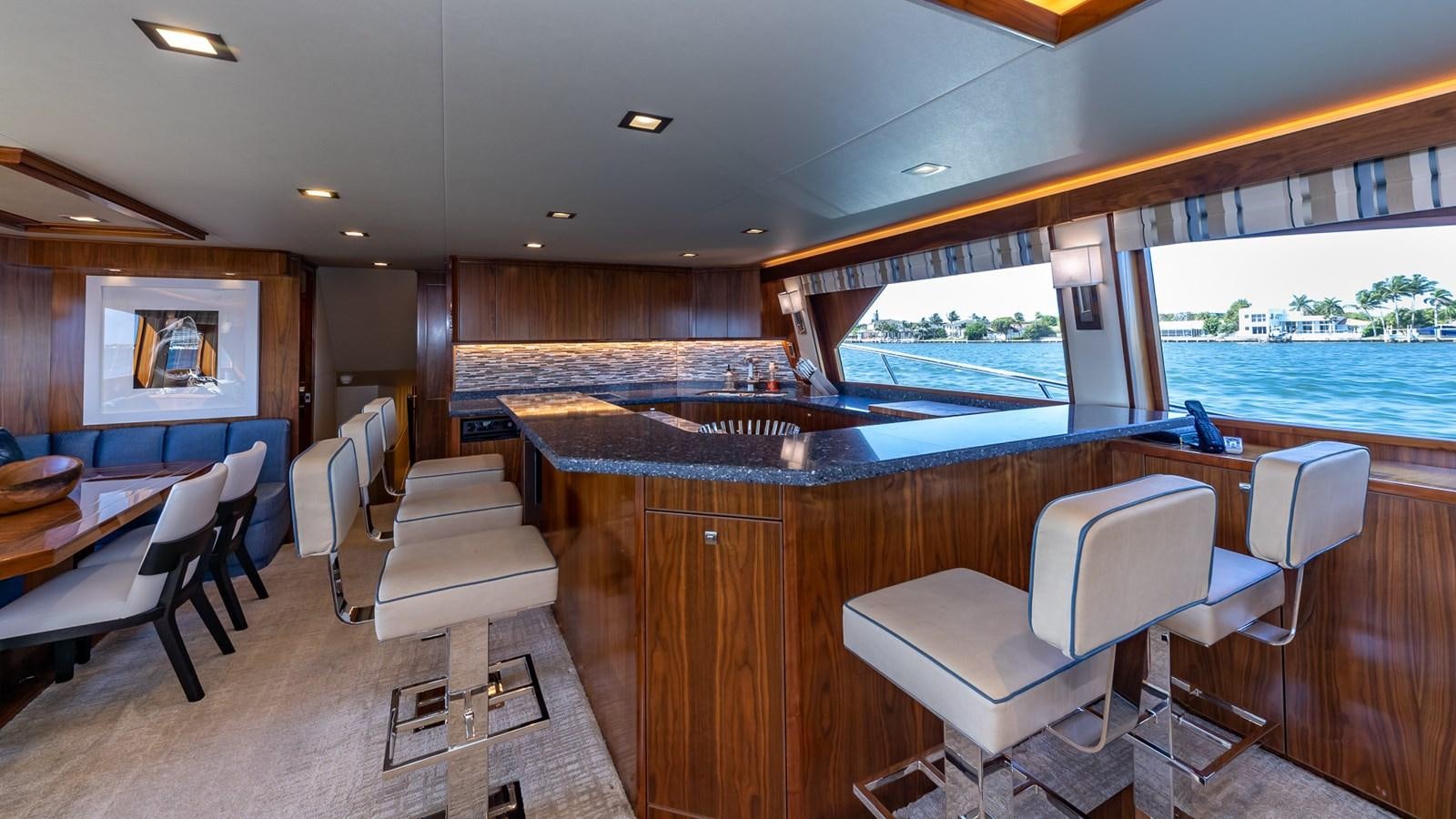a room with a table chairs and a large window aboard AUSSIE RULES Yacht for Sale