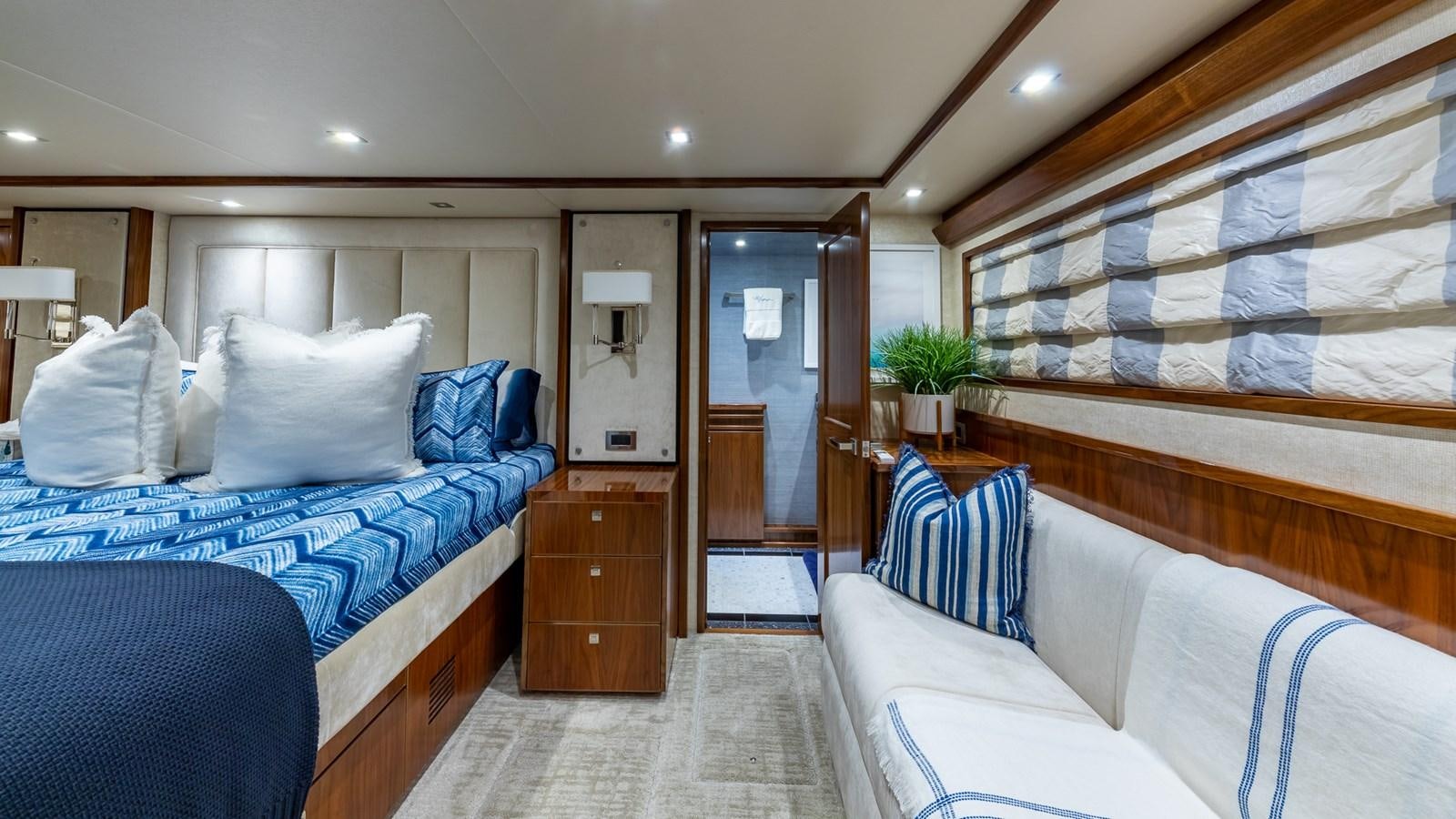 a room with a bed and a dresser aboard AUSSIE RULES Yacht for Sale