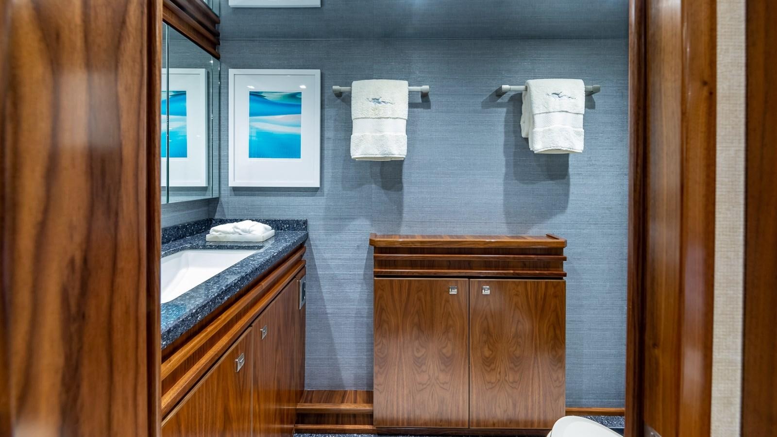 a bathroom with a sink and a mirror aboard AUSSIE RULES Yacht for Sale