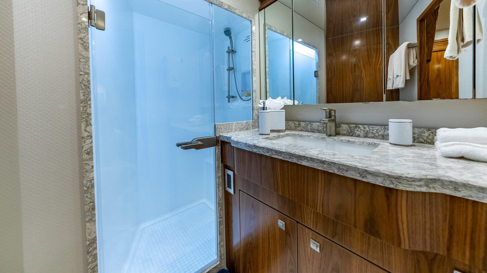 a bathroom with a countertop sink and mirror aboard AUSSIE RULES Yacht for Sale