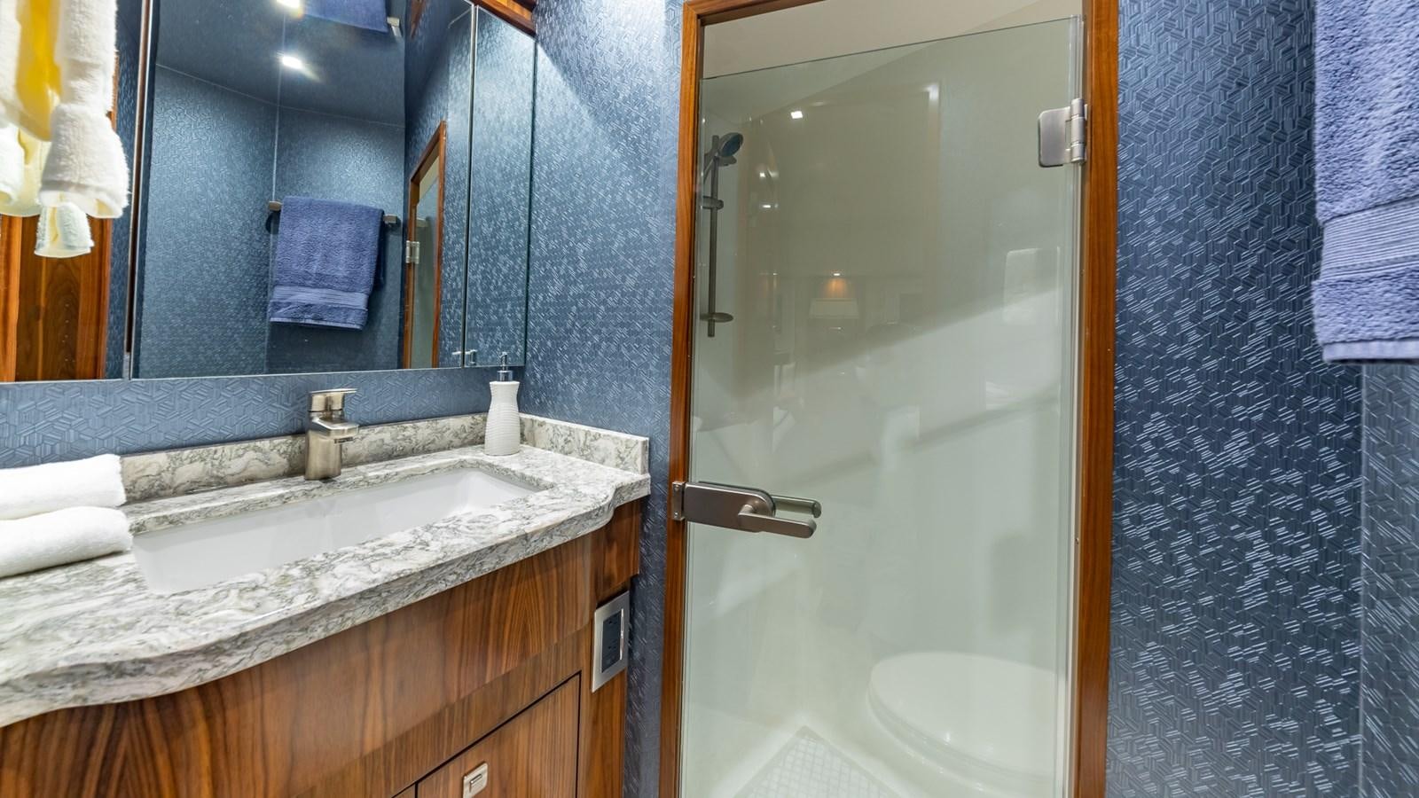 a bathroom with a sink and a mirror aboard AUSSIE RULES Yacht for Sale