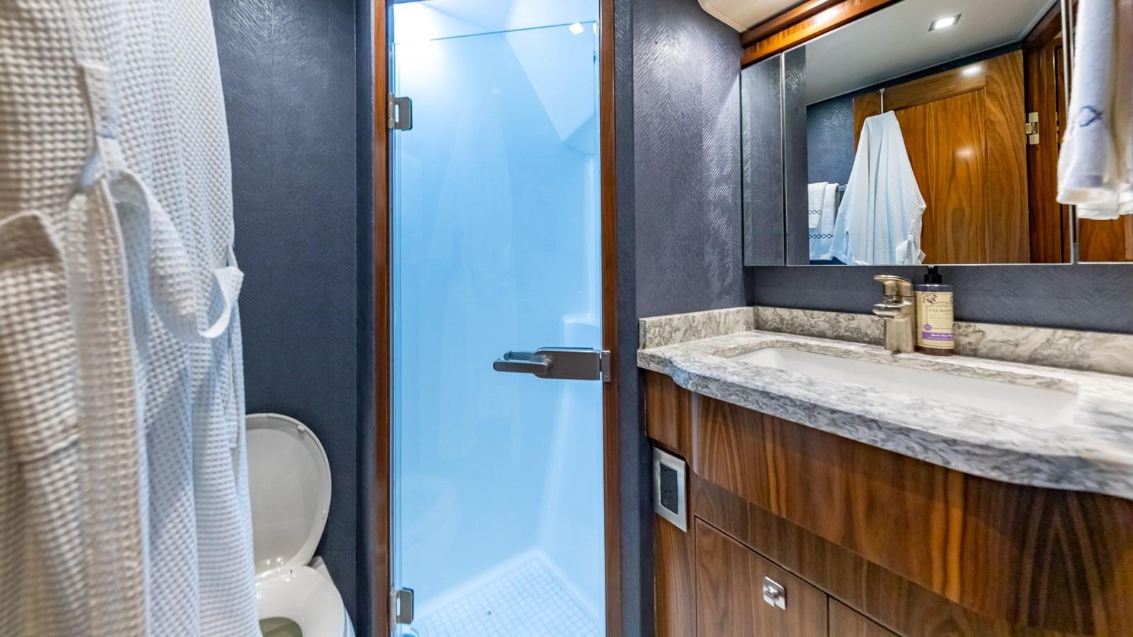 a bathroom with a sink and a mirror aboard AUSSIE RULES Yacht for Sale