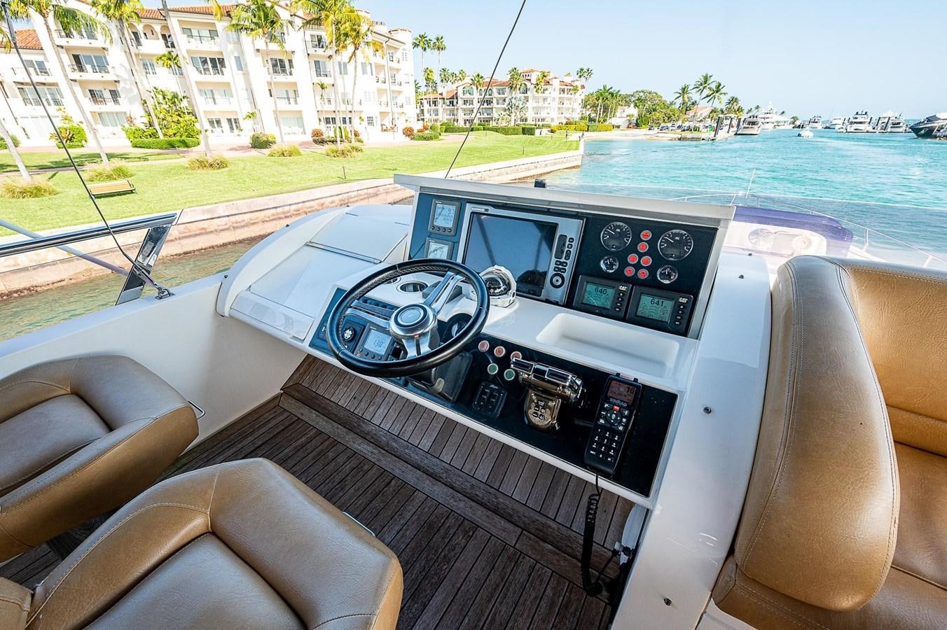 a steering wheel and dashboard of a car on a boat aboard PRINCESS 72 MOTOR YACHT Yacht for Sale