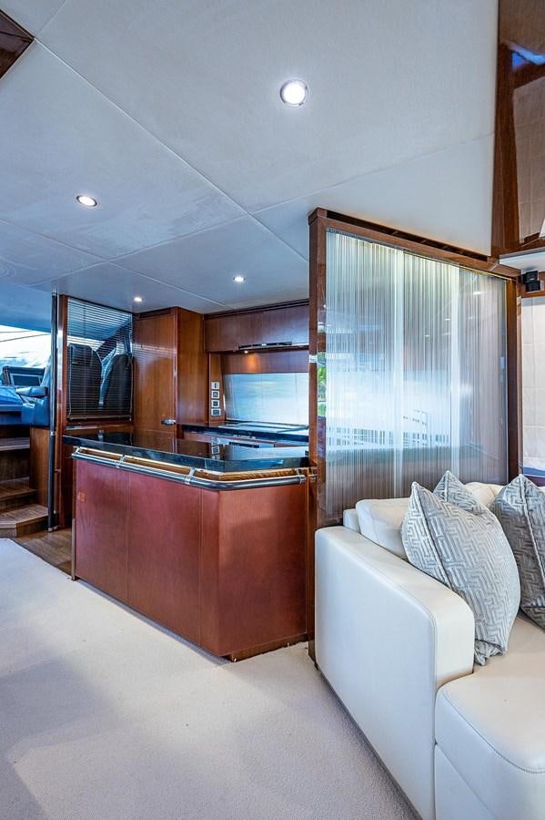 a living room with a couch and a sliding glass door aboard PRINCESS 72 MOTOR YACHT Yacht for Sale