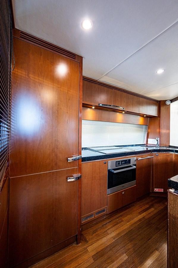 a kitchen with wooden cabinets aboard PRINCESS 72 MOTOR YACHT Yacht for Sale