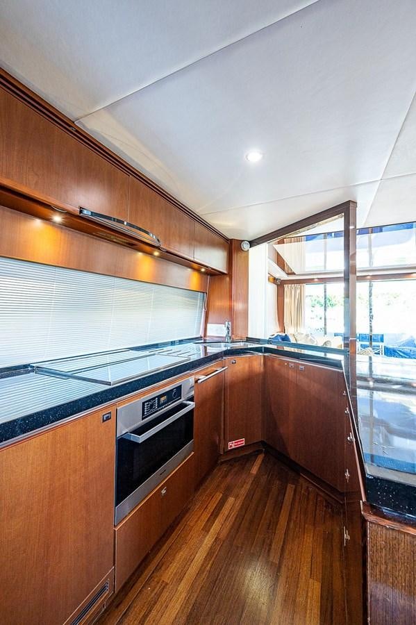 a kitchen with wooden cabinets aboard PRINCESS 72 MOTOR YACHT Yacht for Sale