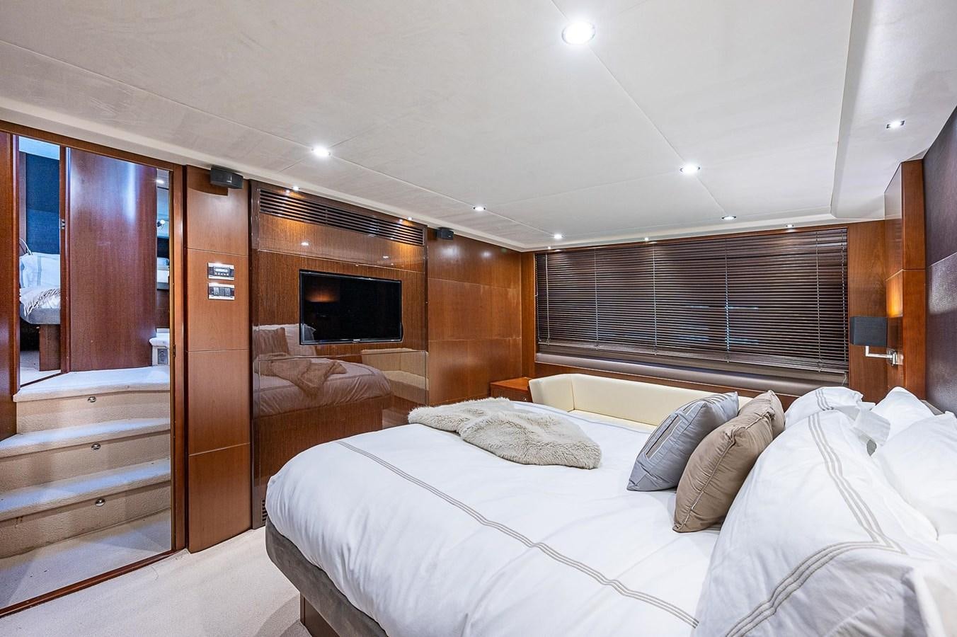 a room with a bed and a television aboard PRINCESS 72 MOTOR YACHT Yacht for Sale