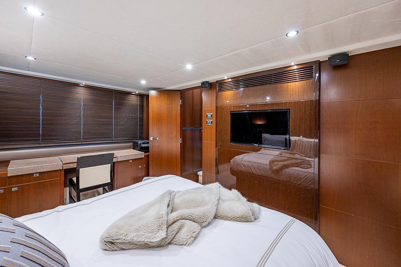 a bedroom with a bed and a fireplace aboard PRINCESS 72 MOTOR YACHT Yacht for Sale