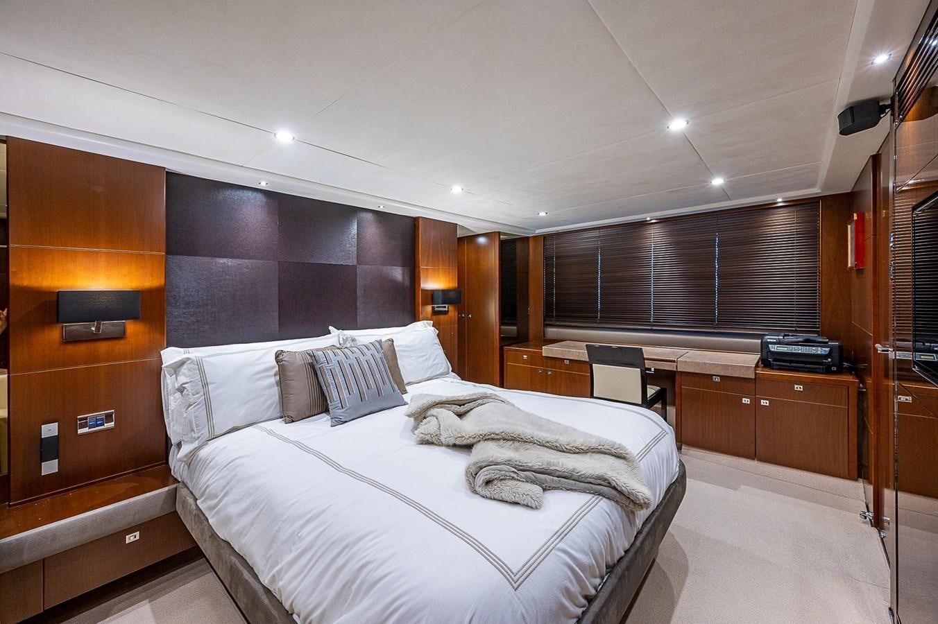 a room with a bed and desk aboard PRINCESS 72 MOTOR YACHT Yacht for Sale