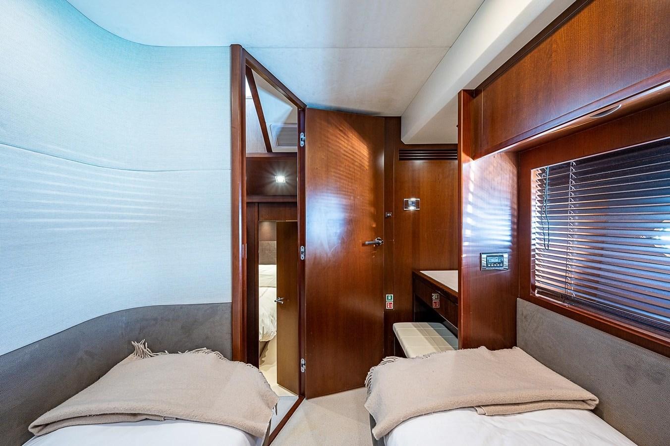 a room with a bed and a window aboard PRINCESS 72 MOTOR YACHT Yacht for Sale