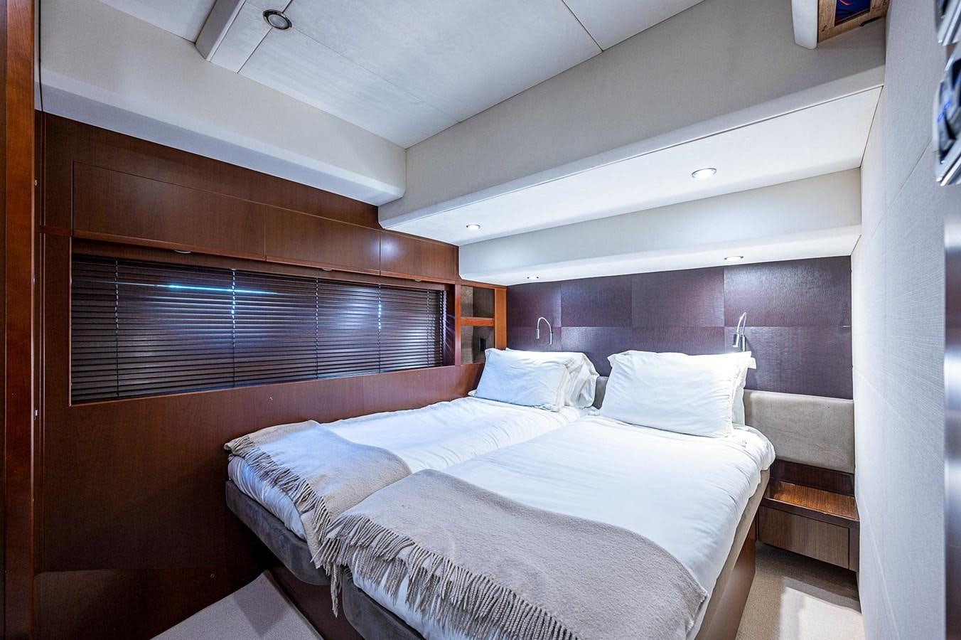 a room with a bed and a window aboard PRINCESS 72 MOTOR YACHT Yacht for Sale