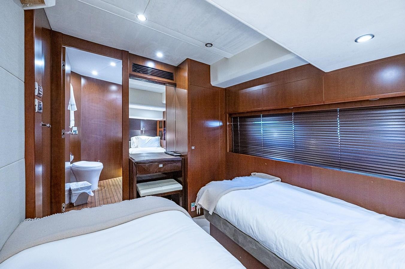 a room with a bed and a desk aboard PRINCESS 72 MOTOR YACHT Yacht for Sale