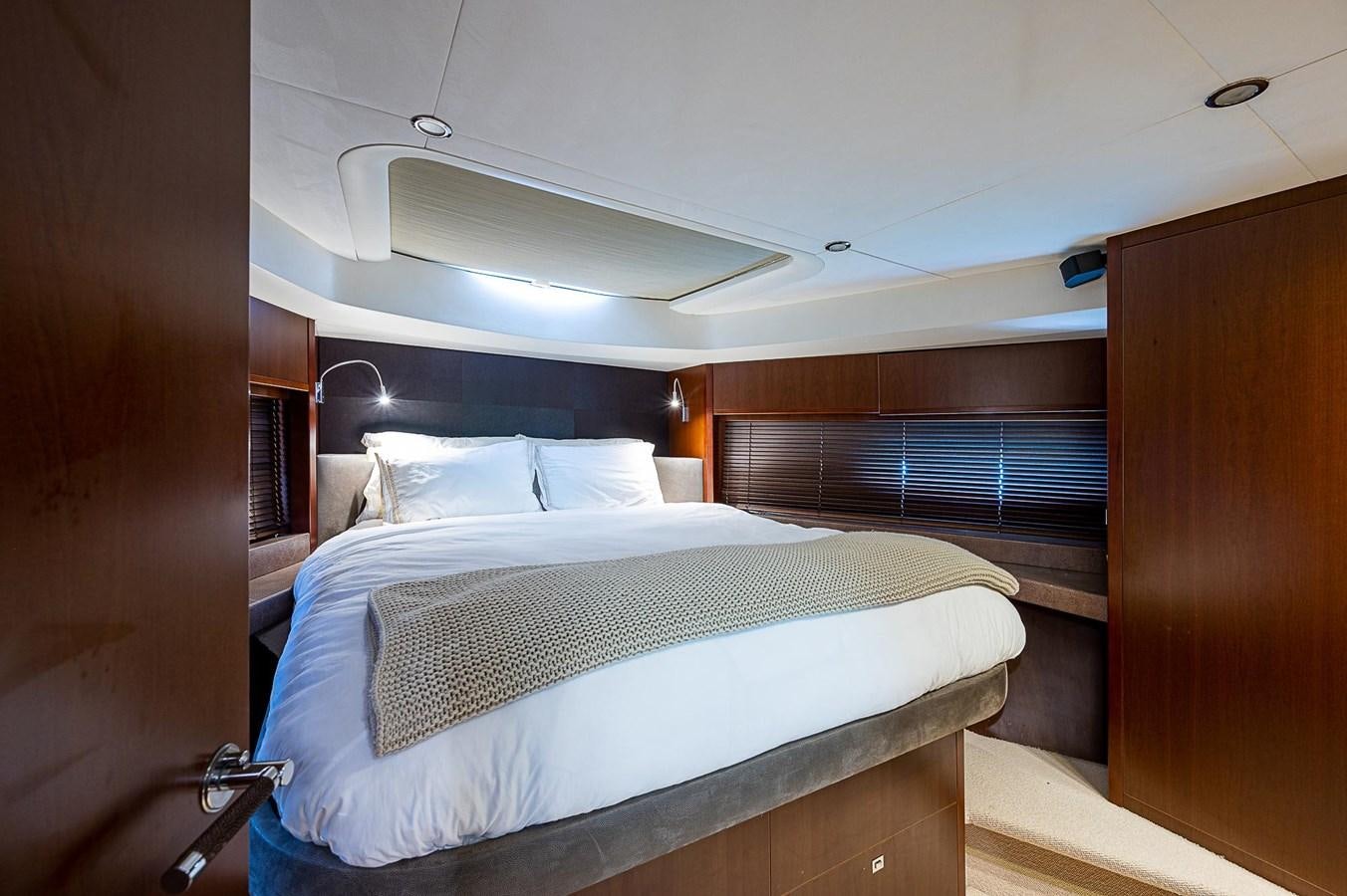 a room with a bed and a desk aboard PRINCESS 72 MOTOR YACHT Yacht for Sale