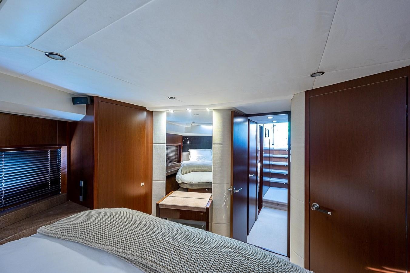 a room with a bed and a door aboard PRINCESS 72 MOTOR YACHT Yacht for Sale