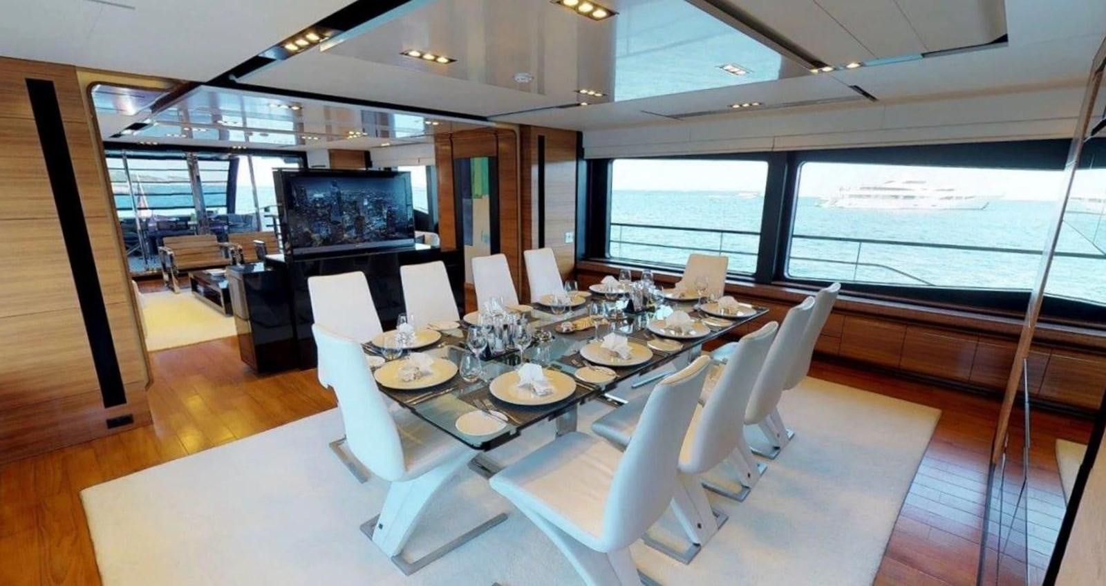 a large conference room with a large table and chairs aboard FUSION Yacht for Charter